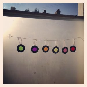 sweet wrapper baubles hanging in a window