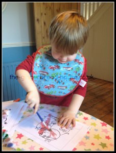toddler painting at a table
