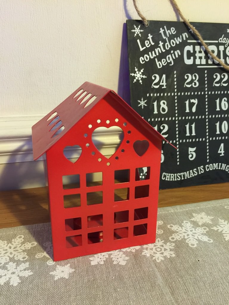 red house shaped candle holder