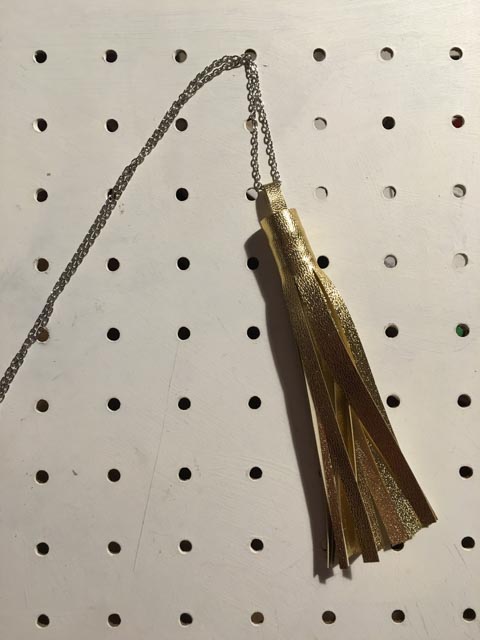 a gold tassle made from faux leather