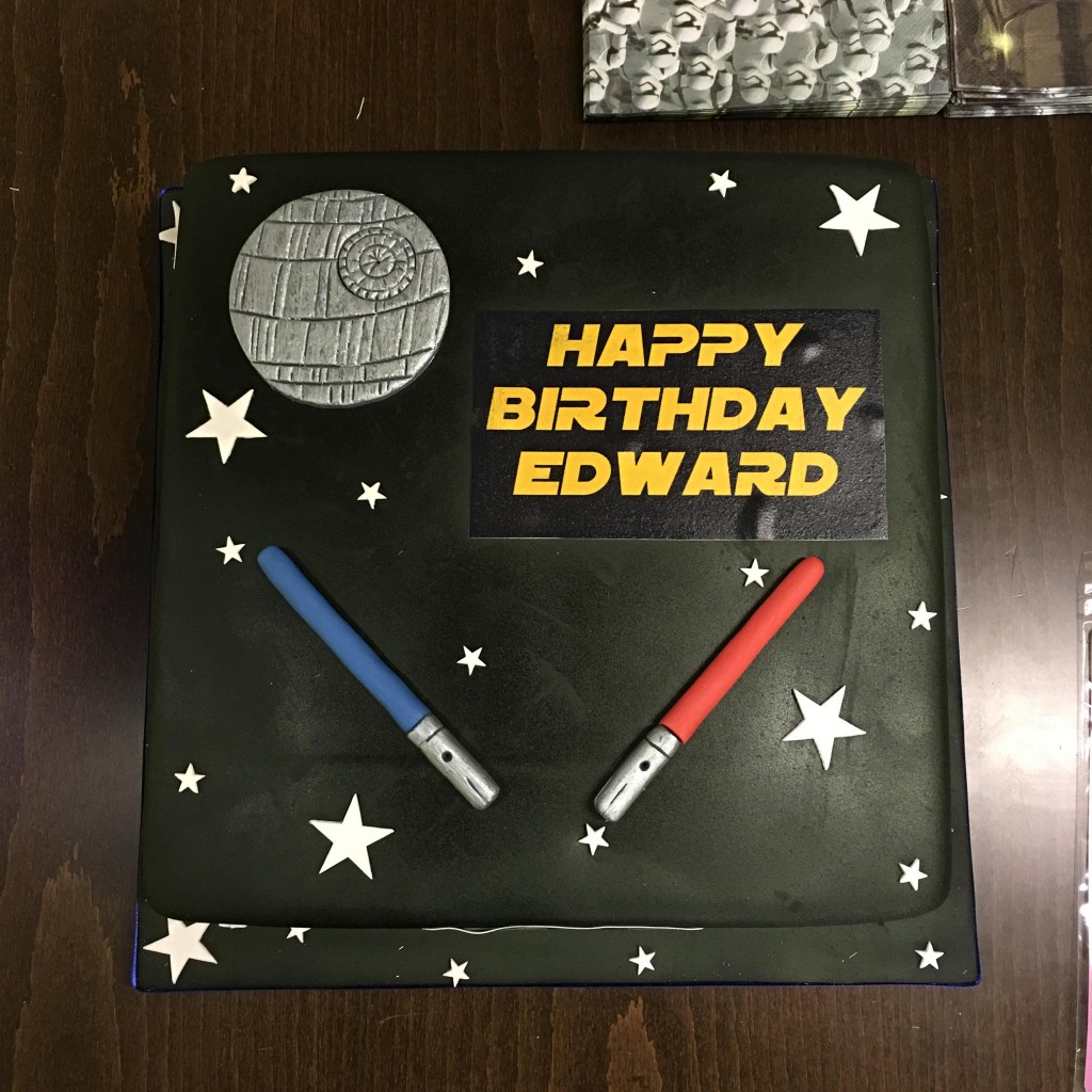 Star Wars birthday cake with Millennium Falcon and light sabers