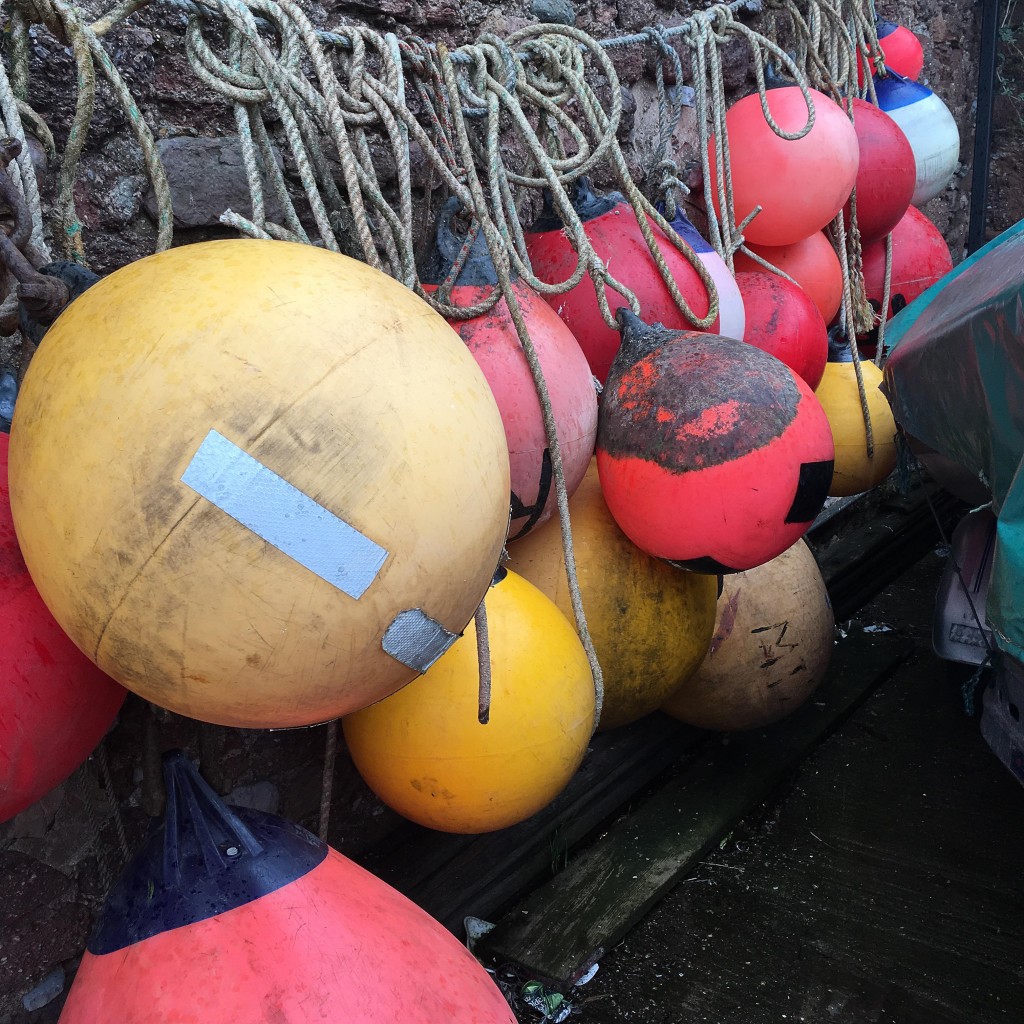 mooring buoys tied together on a wall