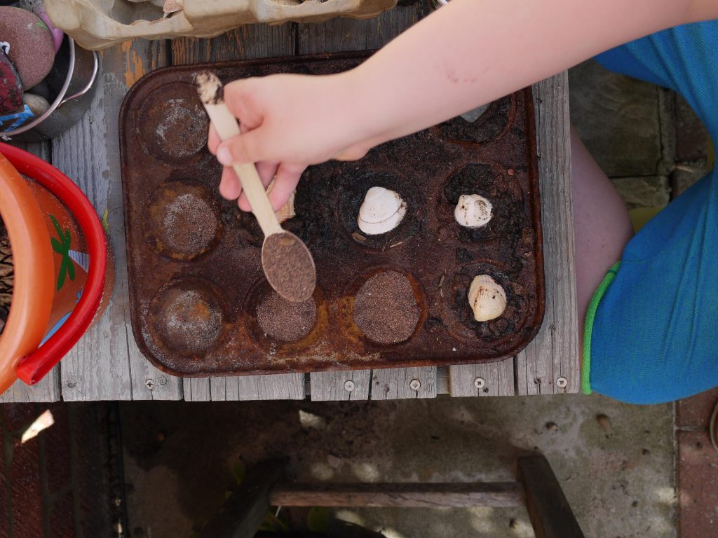 a beach themed mud kitchen Invitation to play 